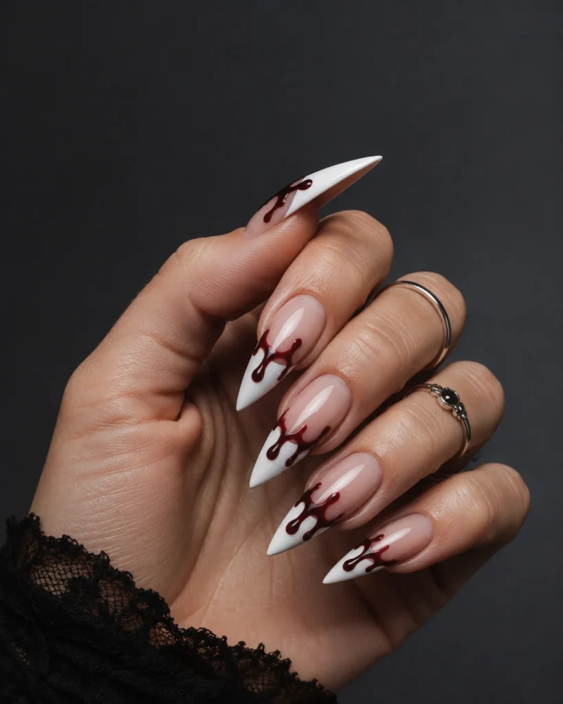 Long white stiletto Halloween nails with glossy red blood-drip art