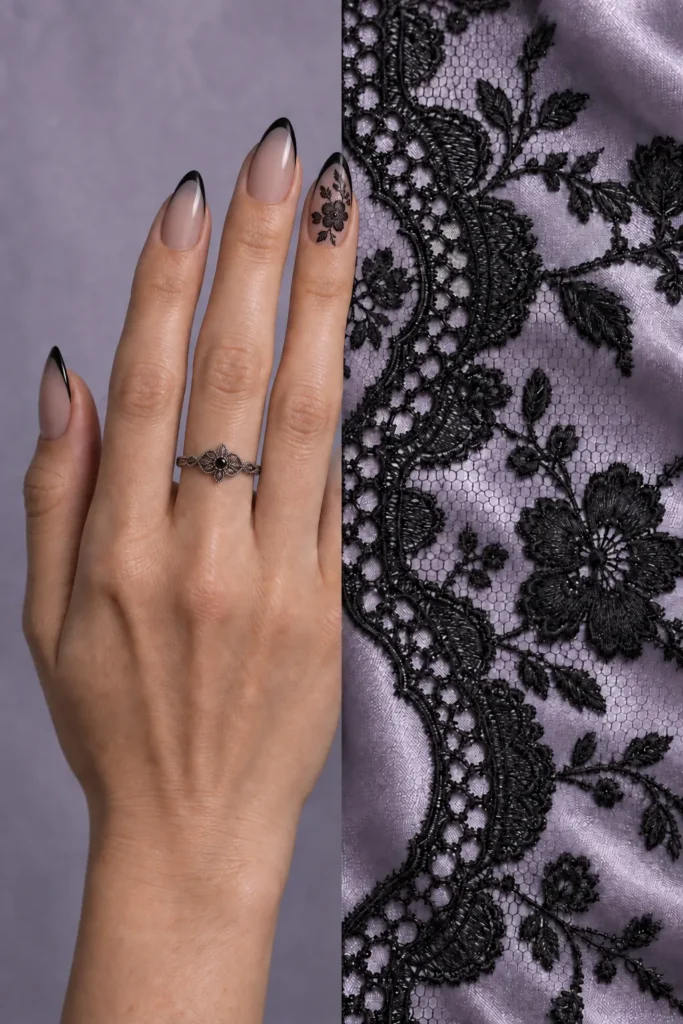 10+ Creative Halloween Nail Designs Inspired by Spooky Details Smoky-nude almond nails with black French tips and black floral artwork on the ring fingernail, above black lace fabric.