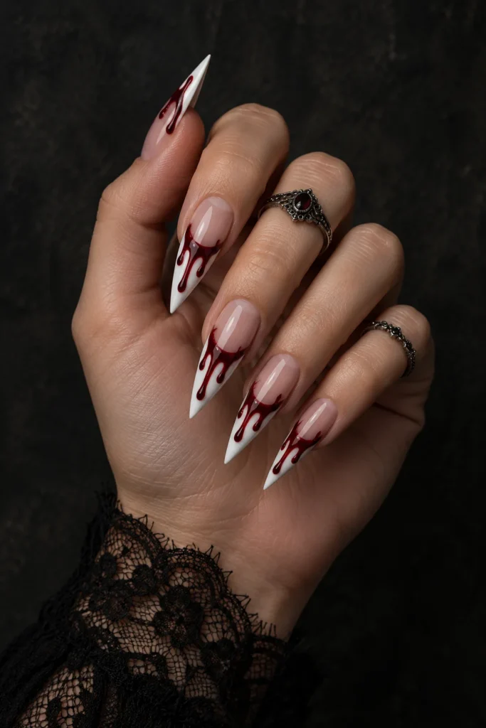 5+ Halloween Blood Drip Nails for a Vampy Manicure Long white stiletto Halloween blood drip nails with glossy oxblood drips over a sheer nude base