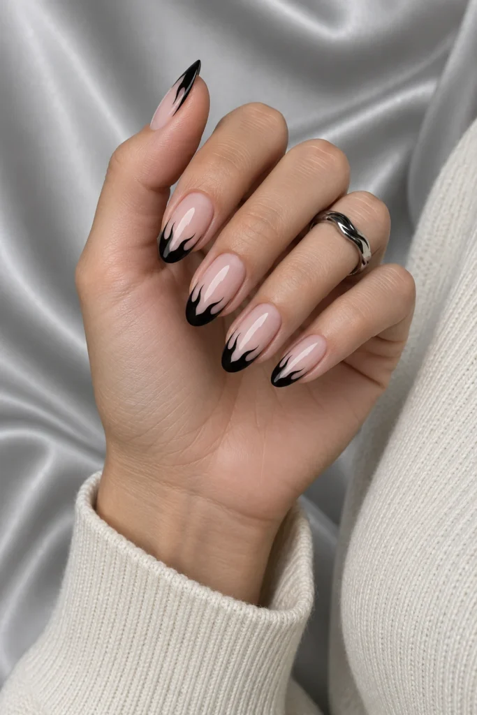9+ Best Halloween French Tip Nails for a Chic October Manicure Halloween French tip nails with glossy black flame-shaped tips.